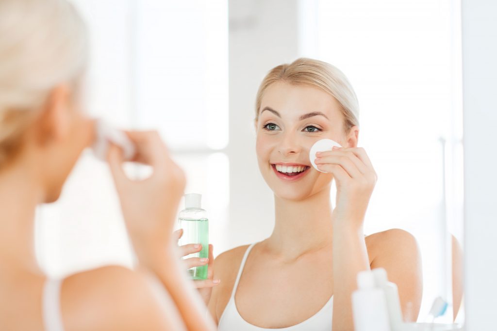 Woman putting cleanser