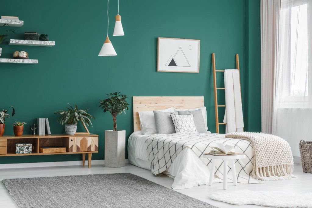 bedroom interior with green painted wall
