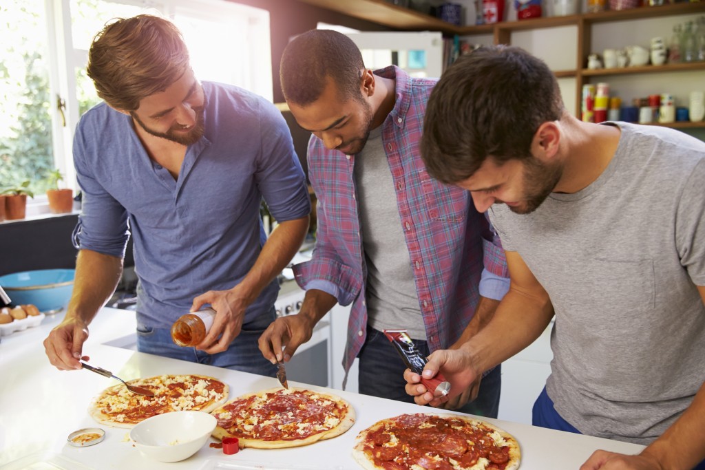 Group of friends making pizza
