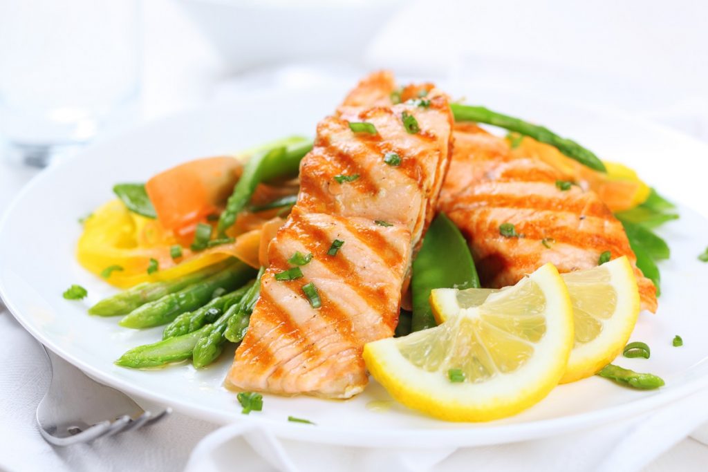 plate of grilled salmon with lemon