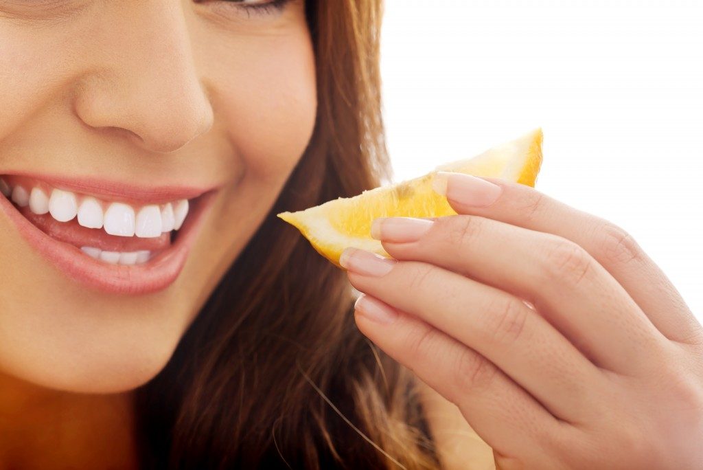 woman eating lemon