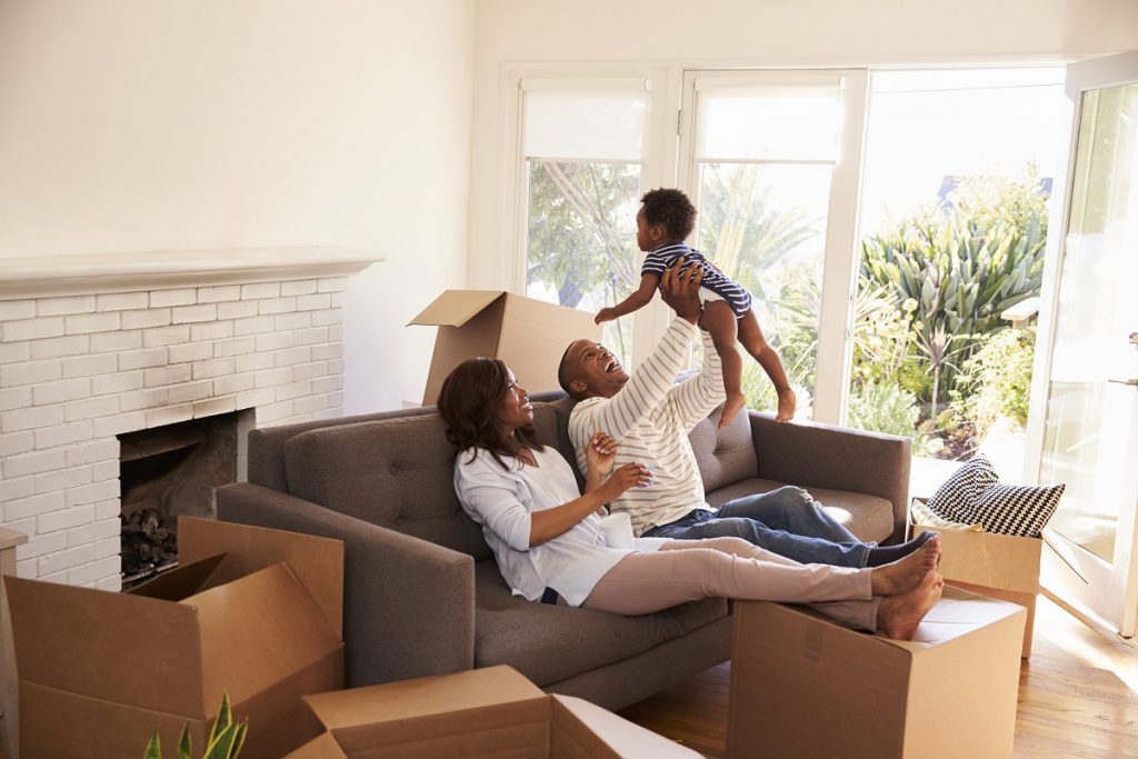 Family-who-just-moved-in-their-new-house-surrounded-by-boxes