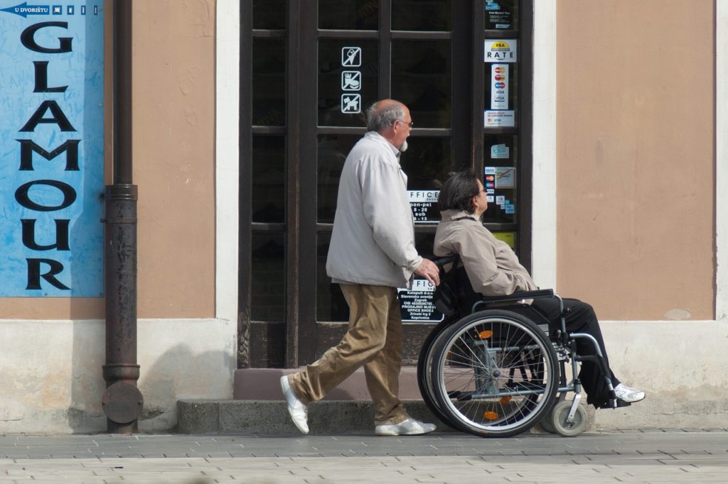 man pushing a woman on a wheelchair
