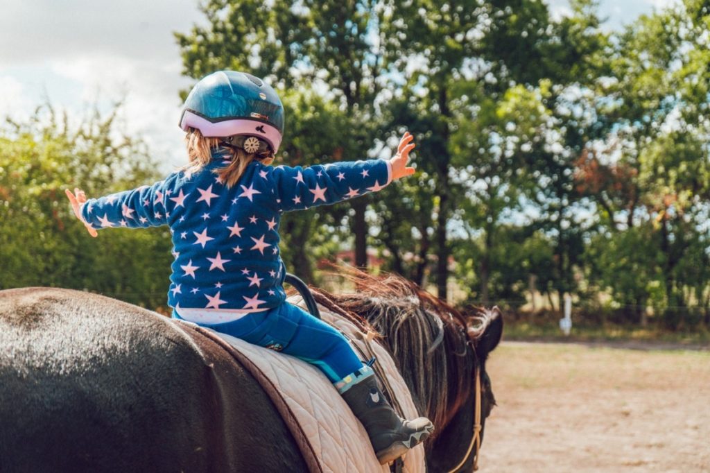 child riding on a horse