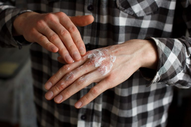 person applying cream on their hand