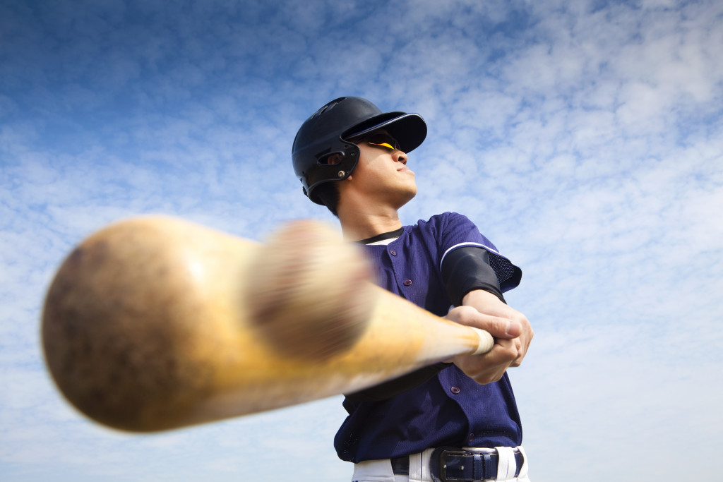 A baseball player hitting a ball with a bat