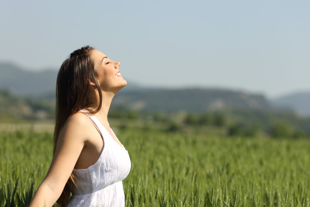 woman breathing in fresh air