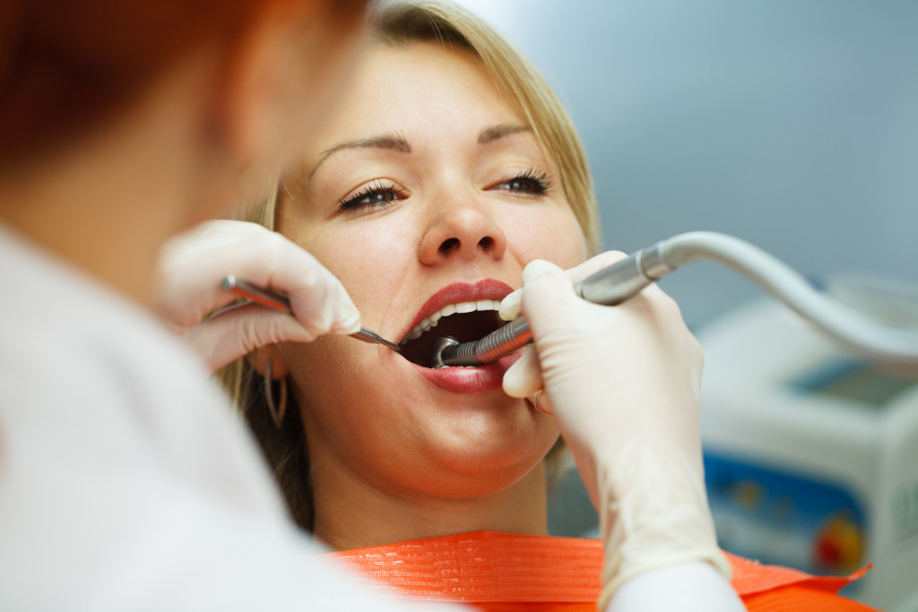 A woman getting a dental procedure in the clinic